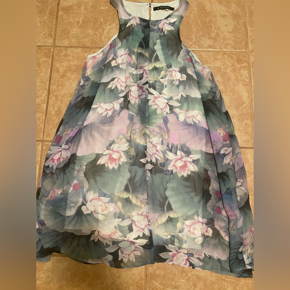 Floral print sleeveless dress. Fitted white layer under floral sheer pattern